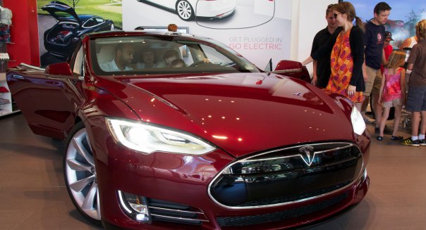 17, June, 2012, Oak Brook, Illinois, USA. Prospective customers consider the new Tesla Motors Model S. The Model S, an all elect