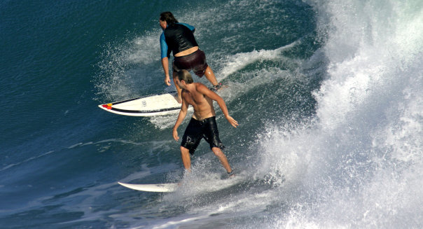 Surfers sharing a wave. Lagundri Bay, Nias, Sumatra, Indonesia, Southeast Asia, Asia